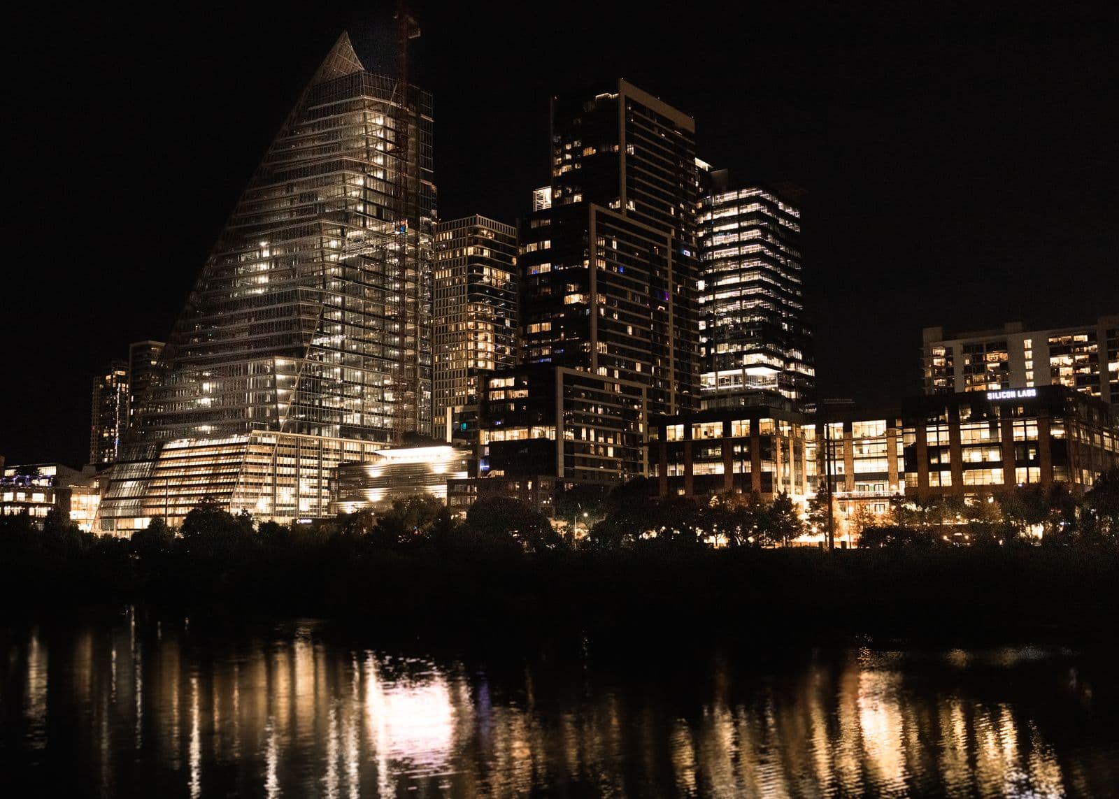 The downtown Austin skyline at night, reflected in Lady Bird Lake